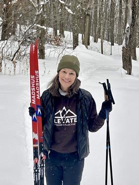 Josee Larocque holding her cross-country skies in the snow
